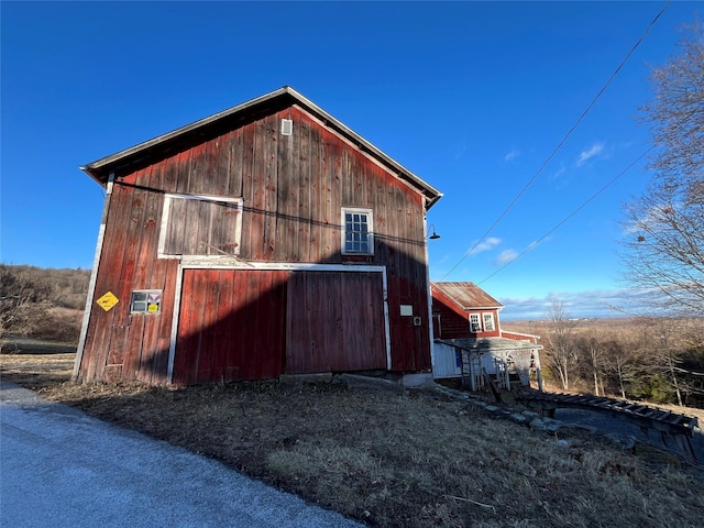 view of property exterior with an outdoor structure