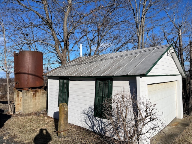 view of side of home featuring an outbuilding and a garage