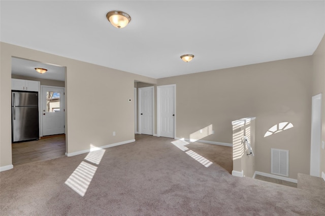 unfurnished room with light carpet