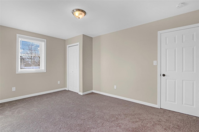 unfurnished bedroom with carpet and a closet