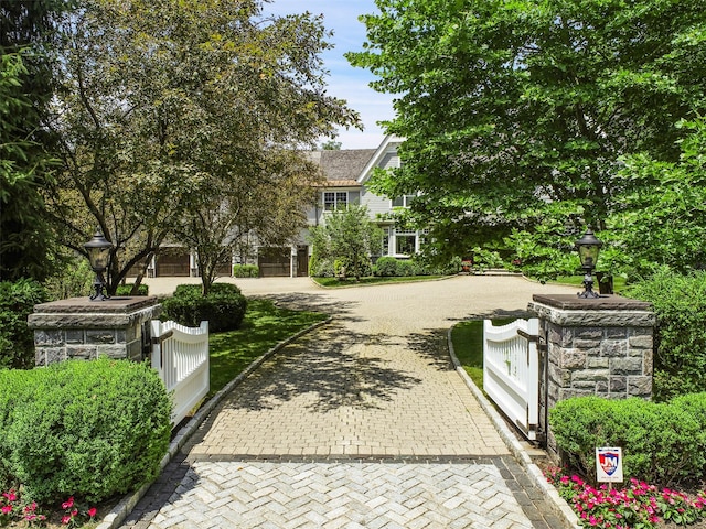 view of community featuring a fenced front yard and a gate