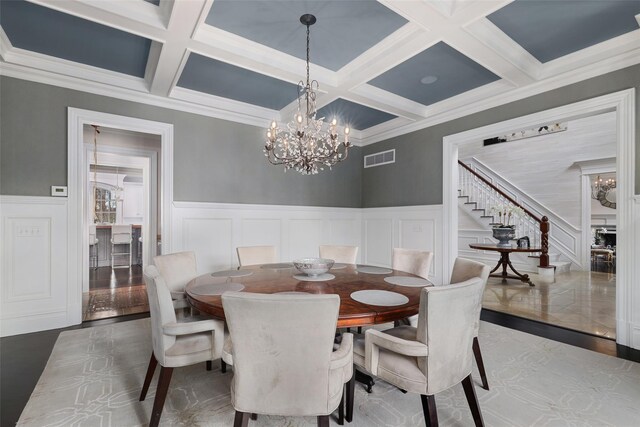 dining room with an inviting chandelier, visible vents, and beam ceiling