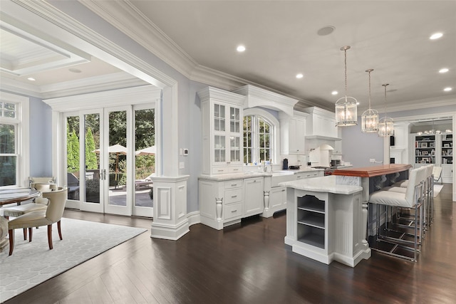 kitchen with open shelves, plenty of natural light, and white cabinetry