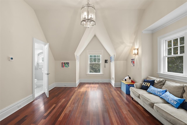 bonus room featuring vaulted ceiling, dark wood-style floors, baseboards, and a chandelier