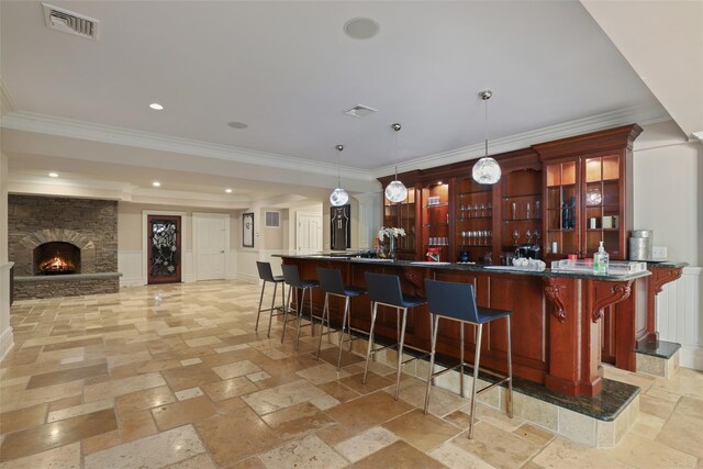 bar featuring visible vents, decorative light fixtures, stone tile floors, recessed lighting, and a fireplace