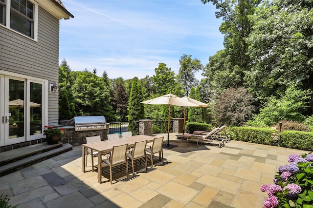 view of patio with outdoor dining area and area for grilling