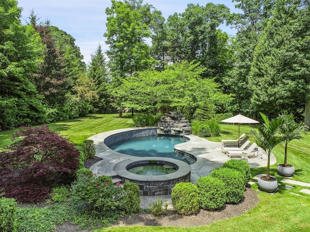 view of pool featuring a patio, a lawn, and an in ground hot tub