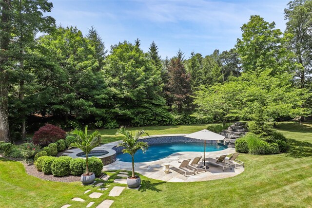 pool featuring a lawn, an in ground hot tub, and a patio