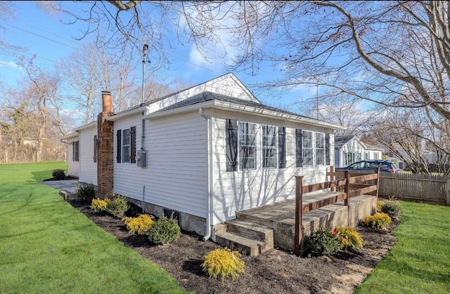 view of side of property with a yard