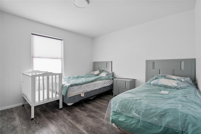 bedroom with dark wood-type flooring