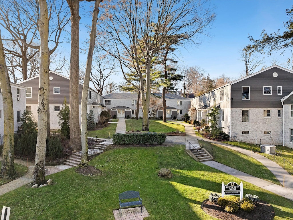 view of property's community featuring a lawn