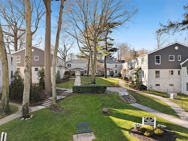 view of property's community featuring a lawn