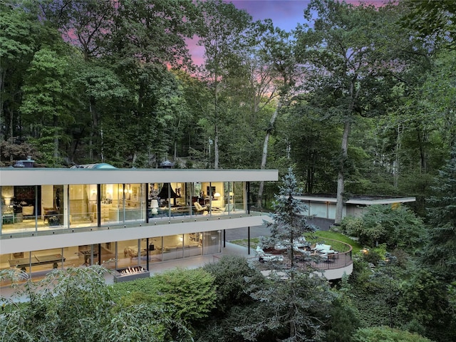 view of back house at dusk