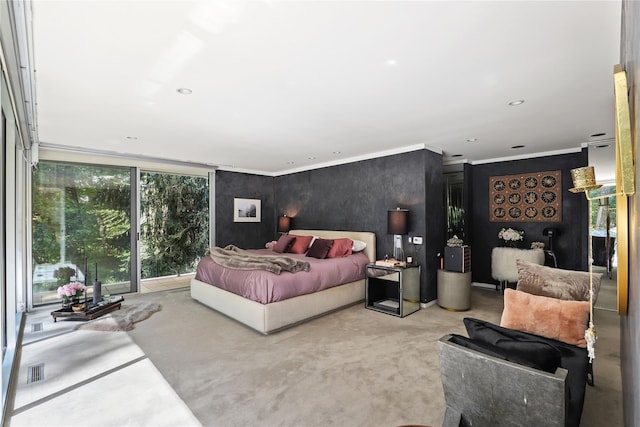 carpeted bedroom featuring crown molding and expansive windows