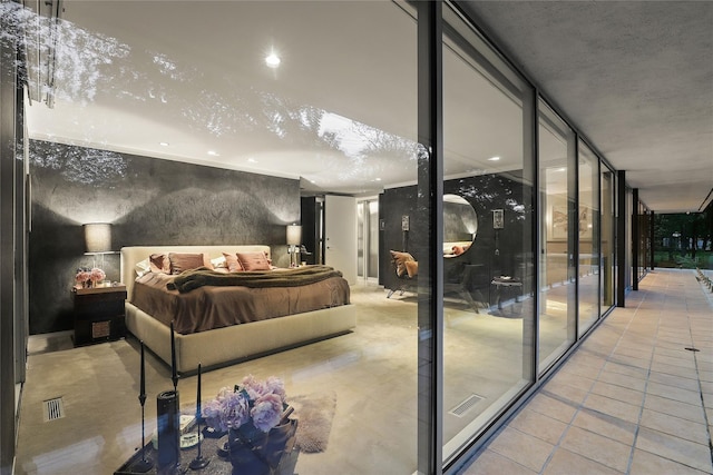 bedroom featuring a wall of windows and light tile patterned flooring