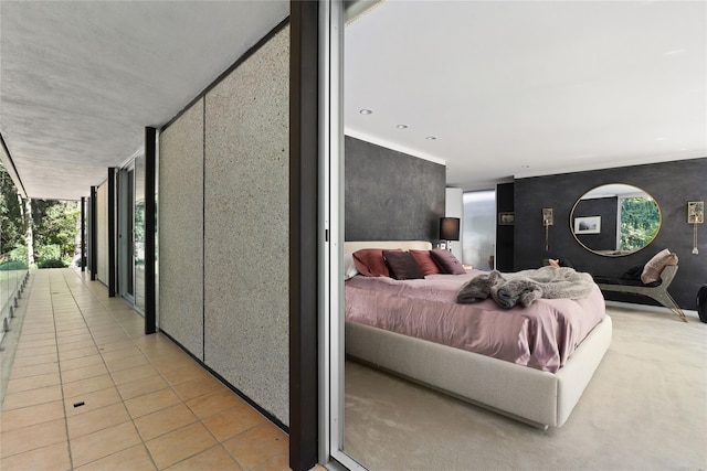 tiled bedroom featuring multiple windows and floor to ceiling windows