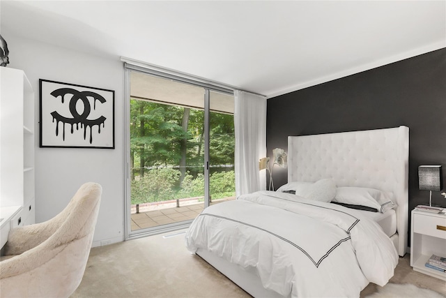 carpeted bedroom featuring a wall of windows and access to exterior