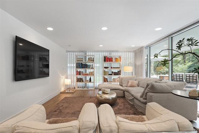 living room with a wall of windows and hardwood / wood-style flooring