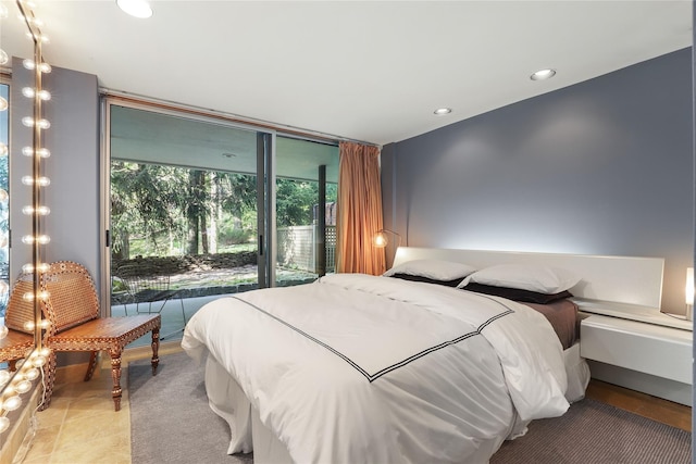 bedroom with floor to ceiling windows and access to exterior