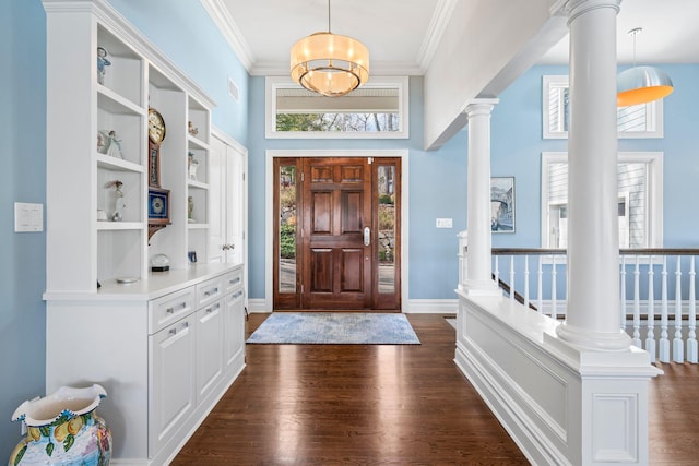 entrance foyer featuring crown molding, dark hardwood / wood-style flooring, and decorative columns