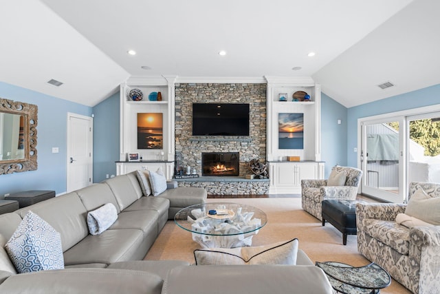 living room featuring vaulted ceiling and a stone fireplace