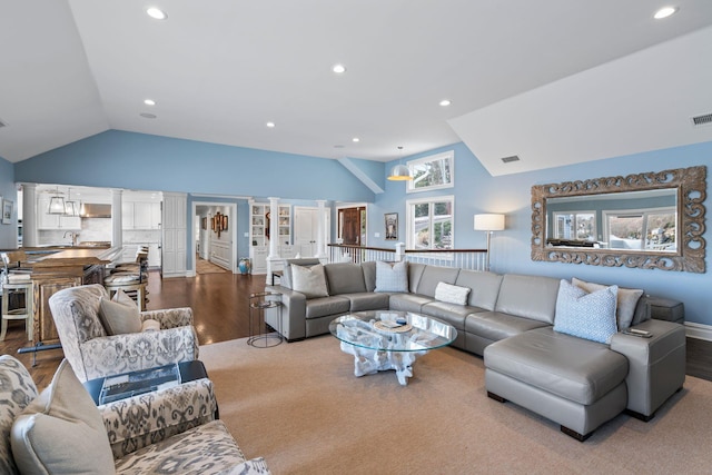 living room featuring lofted ceiling and hardwood / wood-style floors