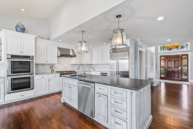 kitchen featuring white cabinetry, wall chimney exhaust hood, stainless steel appliances, and sink