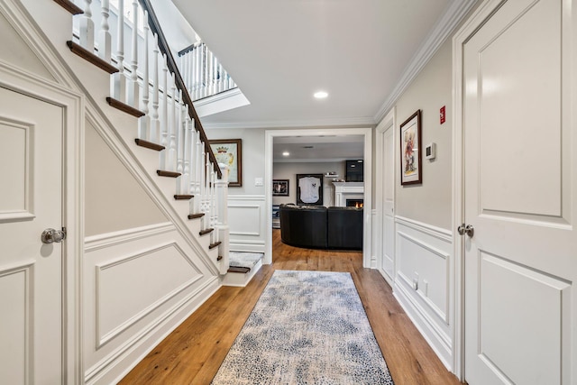 interior space featuring crown molding and wood-type flooring