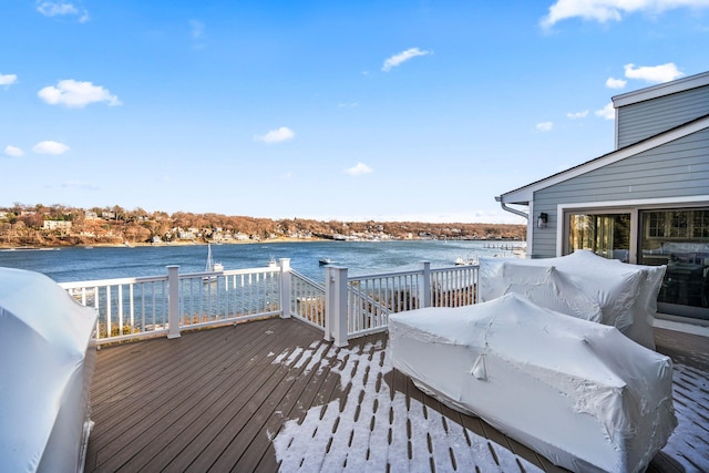 wooden deck featuring a water view and grilling area