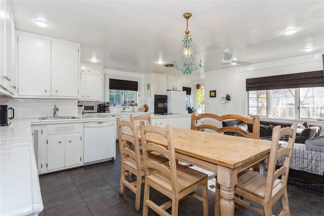 dining area with dark tile patterned flooring and sink