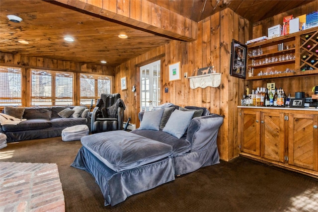 carpeted living room with baseboard heating, indoor bar, wooden walls, and wooden ceiling