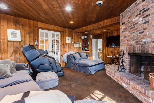 carpeted living room with a brick fireplace, wood ceiling, french doors, and wooden walls