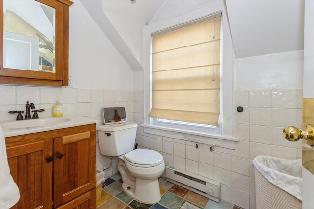 bathroom with toilet, a baseboard radiator, lofted ceiling, tile walls, and vanity