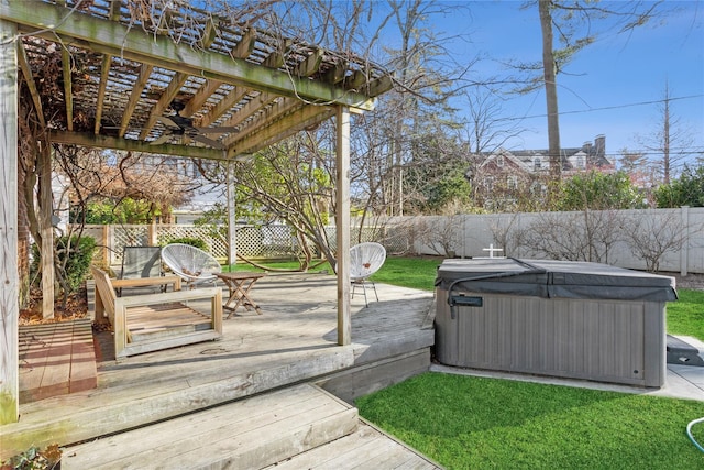 wooden terrace with ceiling fan, a hot tub, and a pergola