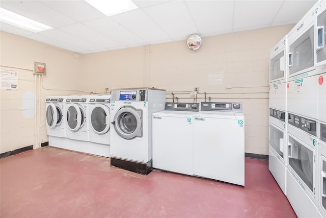 laundry area with stacked washing maching and dryer and washing machine and clothes dryer