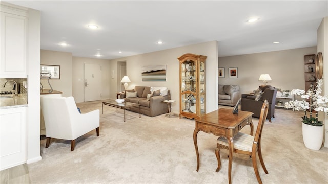 living room featuring sink and light colored carpet