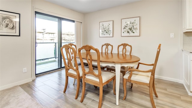 dining space with light wood-type flooring