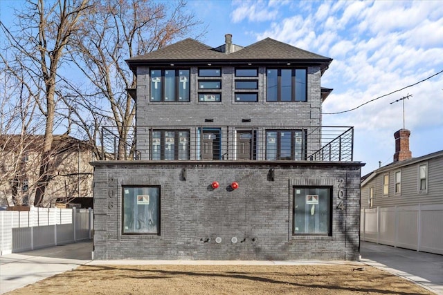 view of front of home featuring a balcony and a patio