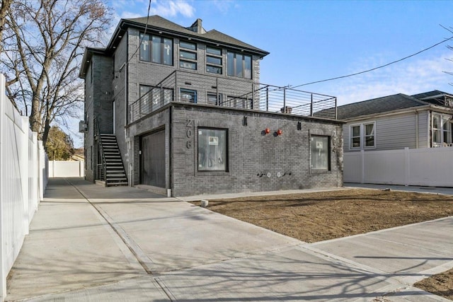 view of front of home featuring a balcony and a garage