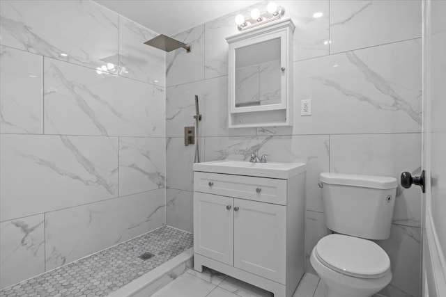 bathroom with vanity, toilet, and tiled shower