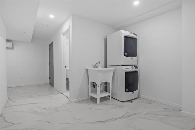 clothes washing area featuring stacked washer / dryer