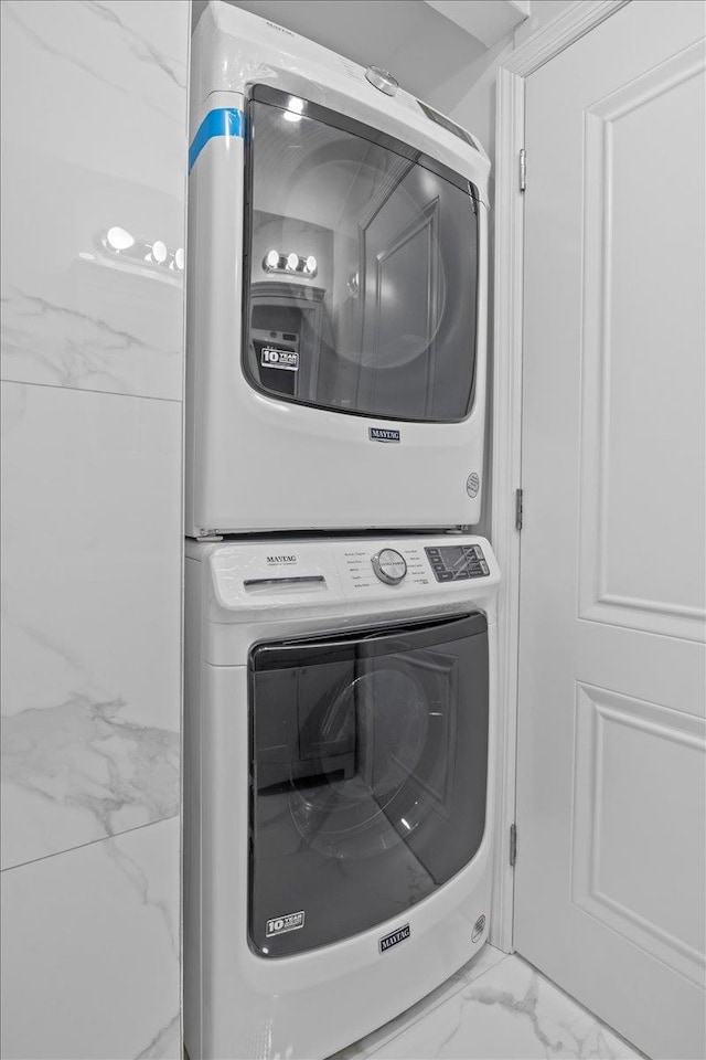 laundry room with stacked washing maching and dryer