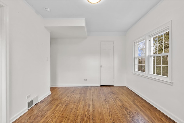 empty room with wood-type flooring