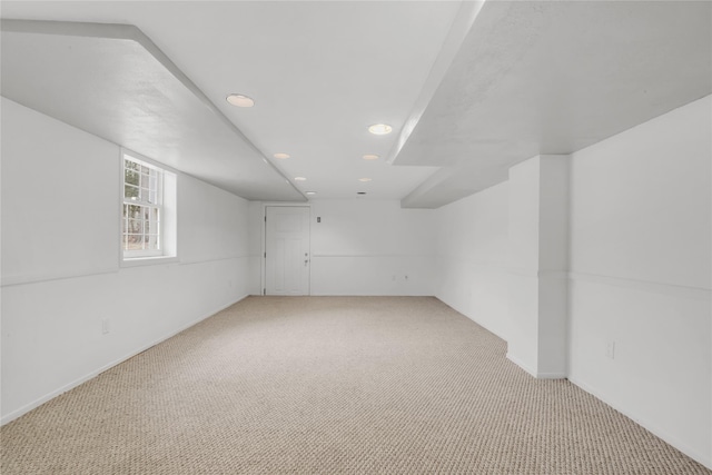 unfurnished room featuring light carpet