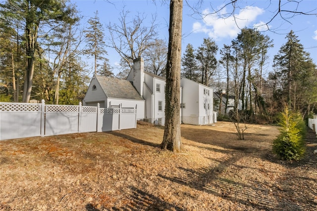 view of side of property with a yard