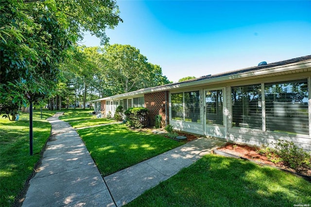 view of side of home featuring a yard