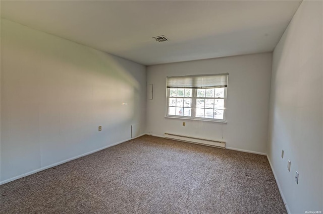 carpeted spare room featuring baseboard heating