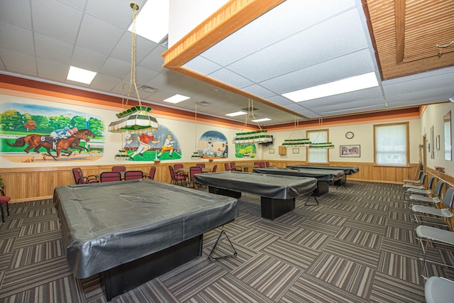 game room featuring dark colored carpet, a drop ceiling, wood walls, and pool table