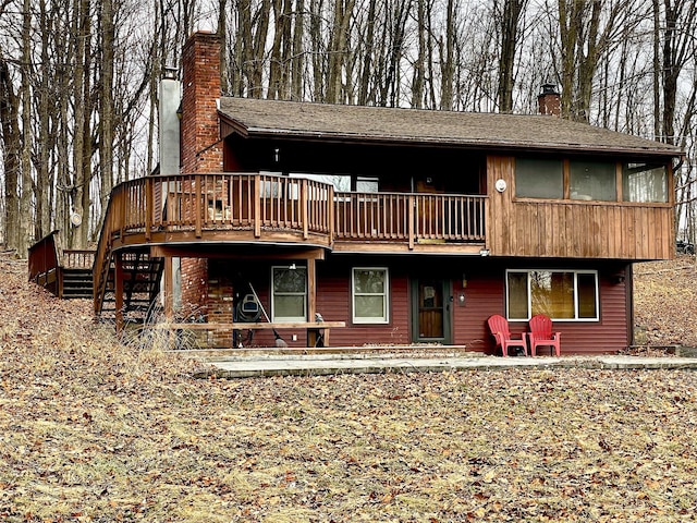 rear view of house featuring a deck