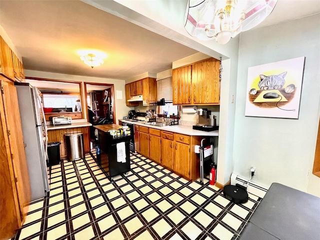 kitchen featuring a center island, white appliances, a baseboard radiator, and sink